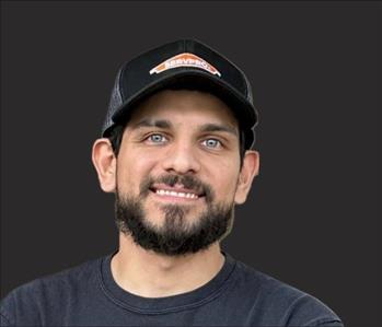 SERVPRO employee in front of black background,