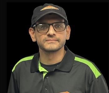 SERVPRO employee in front of black background,