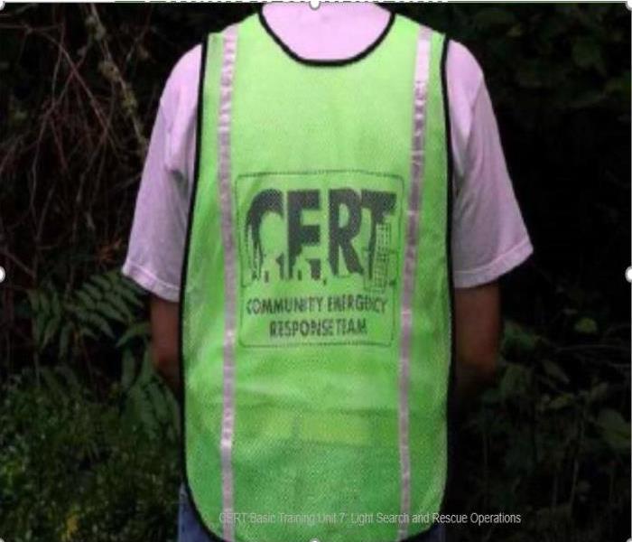 person wearing a green vest with the word CERT