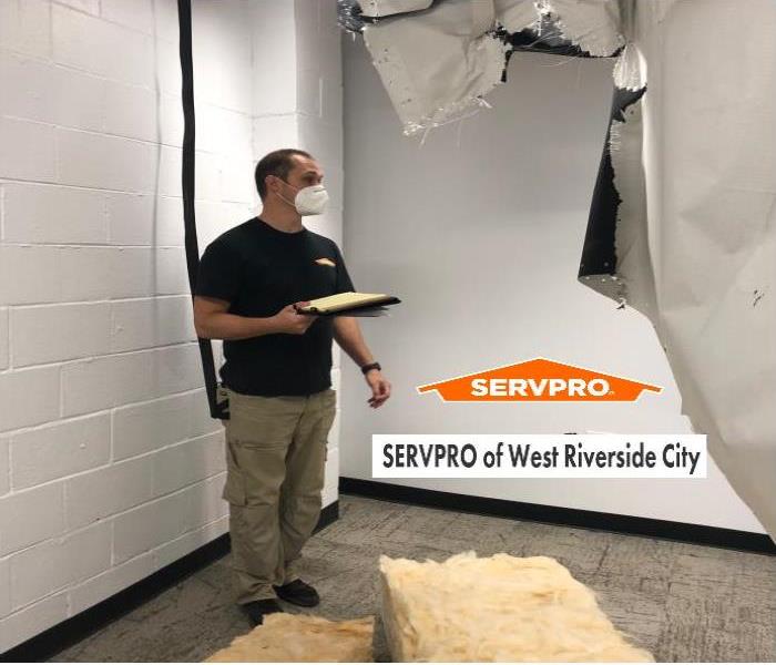 man in SERVPRO t-shirt with a clip board
